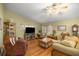 Cozy living room featuring hardwood floors, comfortable seating, and a ceiling fan at 9710 Sw 96Th St, Ocala, FL 34481