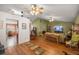 Bright living room featuring wood floors and ceiling fans at 9710 Sw 96Th St, Ocala, FL 34481