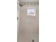 Tiled shower stall featuring a safety bar, hexagon tiling, and a frosted glass window to let in natural light at 9710 Sw 96Th St, Ocala, FL 34481
