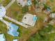 Aerial view of home and property, including pool, long driveway, sheds, and mature landscaping at 11267 Sw 51St Ave, Ocala, FL 34476