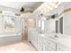 Bright primary bathroom featuring dual sinks, a walk-in shower, and a separate tub at 11267 Sw 51St Ave, Ocala, FL 34476