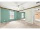 Bright bedroom with large window, ceiling fan, and closet with mirrored doors at 11267 Sw 51St Ave, Ocala, FL 34476