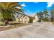 Attractive home exterior with well-maintained lawn, mature landscaping, and a long driveway at 11267 Sw 51St Ave, Ocala, FL 34476