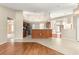 Open-concept kitchen features dark cabinets, stainless steel appliances, and tile flooring at 11267 Sw 51St Ave, Ocala, FL 34476