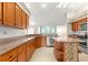 Spacious kitchen featuring wood cabinetry, granite countertops, and stainless steel appliances at 11267 Sw 51St Ave, Ocala, FL 34476