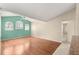Open-concept living room with wood floors, high ceilings, and access to the bathroom at 11267 Sw 51St Ave, Ocala, FL 34476