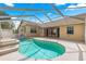 Relaxing covered pool area featuring a kidney-shaped pool and spacious deck at 11267 Sw 51St Ave, Ocala, FL 34476