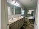 Primary bathroom with dual sinks, shower, and soaking tub, perfect for relaxation at 11644 Nw 21St St, Ocala, FL 34482