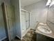 Well-lit bathroom featuring a walk-in shower and dual sinks at 11644 Nw 21St St, Ocala, FL 34482
