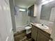 Clean bathroom featuring a shower, bathtub, single sink, and natural-look flooring at 11644 Nw 21St St, Ocala, FL 34482