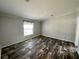Cozy bedroom with wood-look flooring, natural light, and a peaceful atmosphere at 11644 Nw 21St St, Ocala, FL 34482