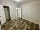 Spacious bedroom with wood-look flooring with access to an en-suite bathroom and a walk-in closet at 11644 Nw 21St St, Ocala, FL 34482