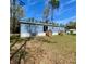 Charming single story home with a bright blue exterior and a spacious lawn at 11644 Nw 21St St, Ocala, FL 34482