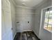 Laundry room featuring washer/dryer hookups, overhead shelf and wood-look flooring at 11644 Nw 21St St, Ocala, FL 34482