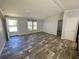 Inviting living room featuring wood-look flooring, plenty of natural light, and a neutral color palette at 11644 Nw 21St St, Ocala, FL 34482