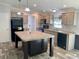 Spacious living room with wood-look flooring and open concept design to kitchen area at 11644 Nw 21St St, Ocala, FL 34482