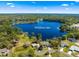 Beautiful aerial view of homes and scenic Waldena Lake surrounded by lush green trees under clear blue skies at 1192 Ne 130Th Ter, Silver Springs, FL 34488