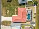 Aerial view of property, showcasing a pool with screened enclosure, metal roof, landscaping, and long driveway at 1192 Ne 130Th Ter, Silver Springs, FL 34488