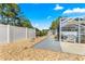 Gravel path leads to a private backyard with a screened lanai, perfect for outdoor relaxation and entertaining at 1192 Ne 130Th Ter, Silver Springs, FL 34488