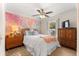 Bright bedroom with a colorful accent wall and a ceiling fan at 1192 Ne 130Th Ter, Silver Springs, FL 34488