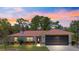 Charming single-story home boasts a metal roof, well-manicured lawn, and a two-car garage at 1192 Ne 130Th Ter, Silver Springs, FL 34488