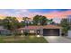 Charming single-story home features a metal roof, well-maintained lawn, and an attached two-car garage at 1192 Ne 130Th Ter, Silver Springs, FL 34488