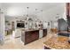 Open kitchen layout with granite countertops, stainless steel appliances, and seamless flow to living area at 1192 Ne 130Th Ter, Silver Springs, FL 34488