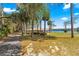 Park view with a walking path leading to the lake and a covered picnic shelter at 1192 Ne 130Th Ter, Silver Springs, FL 34488