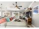 Bright living room with tile floor, cozy seating, and a view of the outdoor pool area at 1192 Ne 130Th Ter, Silver Springs, FL 34488