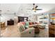 Open-concept living room featuring neutral tones, tile flooring, and a comfortable sectional sofa at 1192 Ne 130Th Ter, Silver Springs, FL 34488