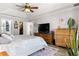 Comfortable main bedroom featuring wood-look floors and a walk-in closet at 1192 Ne 130Th Ter, Silver Springs, FL 34488