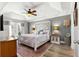 Serene main bedroom boasting decorative headboard, tray ceiling, and access to outdoor patio at 1192 Ne 130Th Ter, Silver Springs, FL 34488