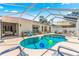 Backyard pool featuring beautiful blue water, cozy lounge chairs, and access to the home's bedroom and living space at 1192 Ne 130Th Ter, Silver Springs, FL 34488