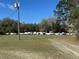 RV and boat parking within a fenced in area on a grassy lot at 1192 Ne 130Th Ter, Silver Springs, FL 34488