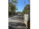 Community street view with mature trees and street access to neighborhood mailboxes at 1192 Ne 130Th Ter, Silver Springs, FL 34488