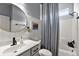 Charming bathroom featuring a shower, round mirror and vanity with modern fixtures and great natural light at 12139 Se 91St Ter, Summerfield, FL 34491