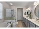 This bathroom features a soaking tub, a glass-enclosed shower, and a double vanity with elegant fixtures at 12139 Se 91St Ter, Summerfield, FL 34491