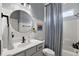 Charming bathroom featuring a shower, round mirror and vanity with modern fixtures and great natural light at 12139 Se 91St Ter, Summerfield, FL 34491