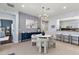 Dining area featuring a modern chandelier, stylish furniture, and open view to the kitchen at 12139 Se 91St Ter, Summerfield, FL 34491