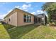 Back exterior view of the home featuring a screened-in patio and lush green lawn at 12139 Se 91St Ter, Summerfield, FL 34491