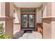 Elegant double front doors with glass panels and a transom window, framed by decorative columns at 12139 Se 91St Ter, Summerfield, FL 34491