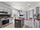 This expansive kitchen features stainless steel appliances, granite countertops and an island with seating at 12139 Se 91St Ter, Summerfield, FL 34491