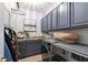 Efficient laundry room with modern washer and dryer, countertop space, and overhead cabinets for storage at 12139 Se 91St Ter, Summerfield, FL 34491