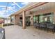 Expansive outdoor patio with dining and lounging areas, complete with a ceiling fan and television for outdoor enjoyment at 12139 Se 91St Ter, Summerfield, FL 34491
