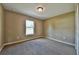 Carpeted bedroom featuring neutral walls, closet and a window with a view at 14230 Se 34Th Ct, Summerfield, FL 34491