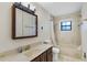 Bathroom features a vanity with sink, mirror and shower/tub combination at 1505 Ne 33Rd Pl, Ocala, FL 34479