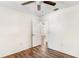 Bright bedroom with wood-look floors, ceiling fan, and closet at 1505 Ne 33Rd Pl, Ocala, FL 34479