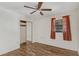 Comfortable bedroom with wood-look floors, closet, and window for natural light at 1505 Ne 33Rd Pl, Ocala, FL 34479