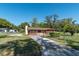 Charming home featuring a long driveway, well-maintained lawn, and inviting curb appeal at 1505 Ne 33Rd Pl, Ocala, FL 34479