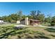 Single Gathering home exterior with fenced yard, detached storage shed, and chimney at 1505 Ne 33Rd Pl, Ocala, FL 34479